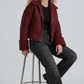 Streetwear fashion lifestyle photograph of a men's heavy winter look featuring a dark maroon suede aviator jacket with warm shearling lining.