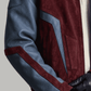 Close-up shot of rich dark red soft suede texture contrasted against dark blue genuine leather sleeve panels.
