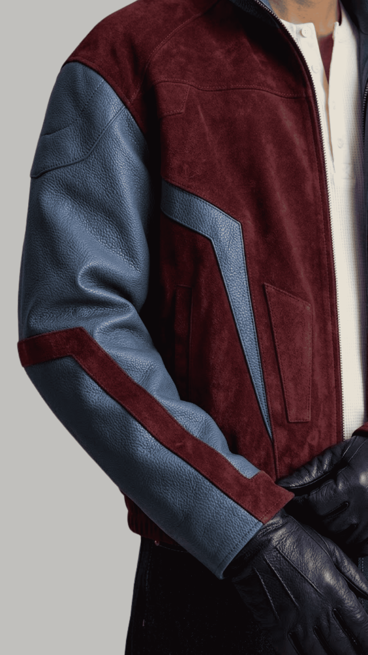 Close-up shot of rich dark red soft suede texture contrasted against dark blue genuine leather sleeve panels.