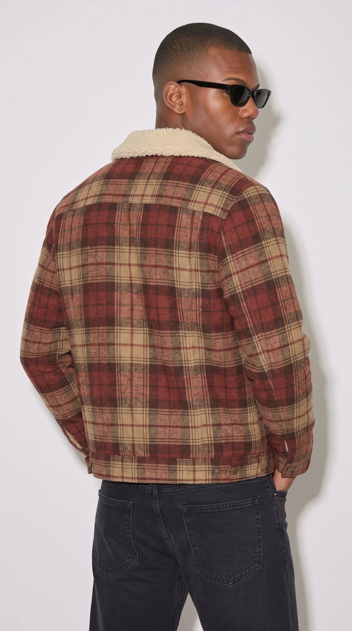 Red-brown windowpane plaid flannel shacket with a relaxed shoulder profile, two button-flap chest pockets, cream shearling-trimmed lapels and a full button-front closure, creating an easy autumn layering piece for dark denim, plain T-shirts and casual winter outfits.