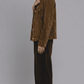 Side-angle profile view displaying the comfortable tailored fit and broad shoulder structure of a men's dark mustard suede jacket.