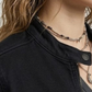 Close up shot of durable high quality black denim fabric weave and metallic button detailing