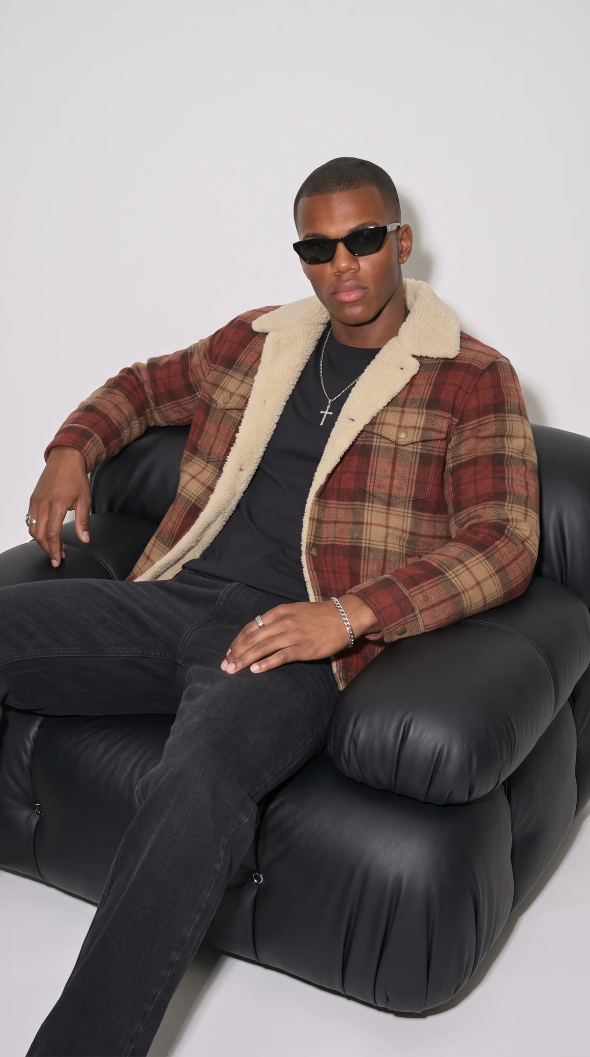 Rust-burgundy and tan checked cotton flannel jacket featuring a clean horizontal shoulder yoke, carefully aligned plaid pattern, vertical panel stitching and a contrasting cream faux-shearling neckline, highlighting its structured construction and classic heritage workwear character.