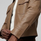 Macro detailed shot highlighting the ultra-smooth grain of the genuine cream beige leather fabric on the front zipper flap.