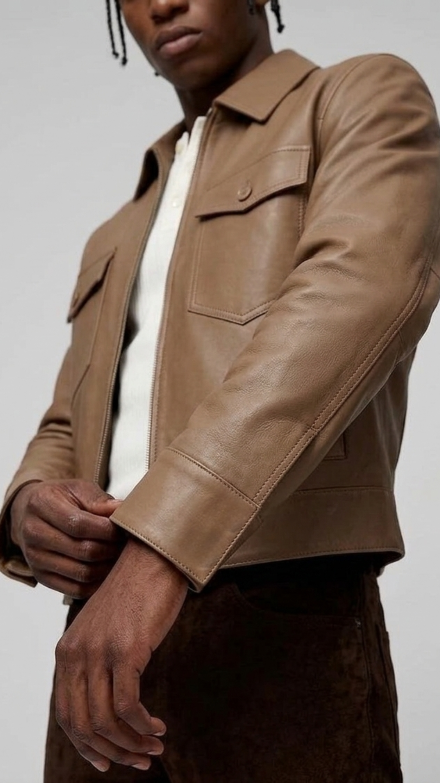 Macro detailed shot highlighting the ultra-smooth grain of the genuine cream beige leather fabric on the front zipper flap.