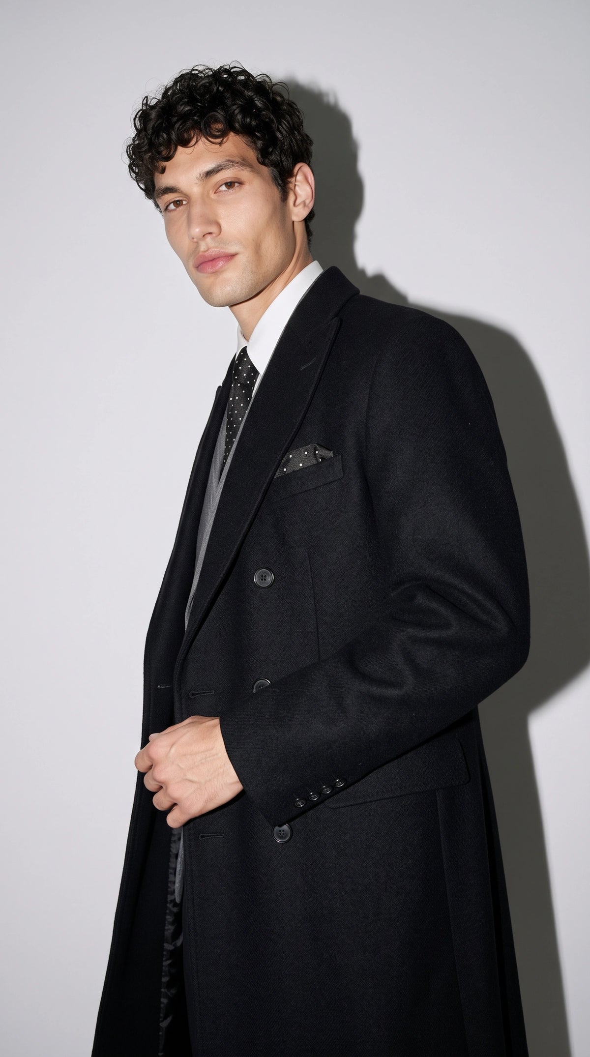 An incredibly engaging Jackero sleek dark black wool overcoat that effortlessly bridges the gap between classic luxury tailoring and bold, contemporary urban street style.