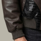 Close-up shot showing the detailed embossing and high-quality finish of the black crocodile pattern on dark brown leather.
