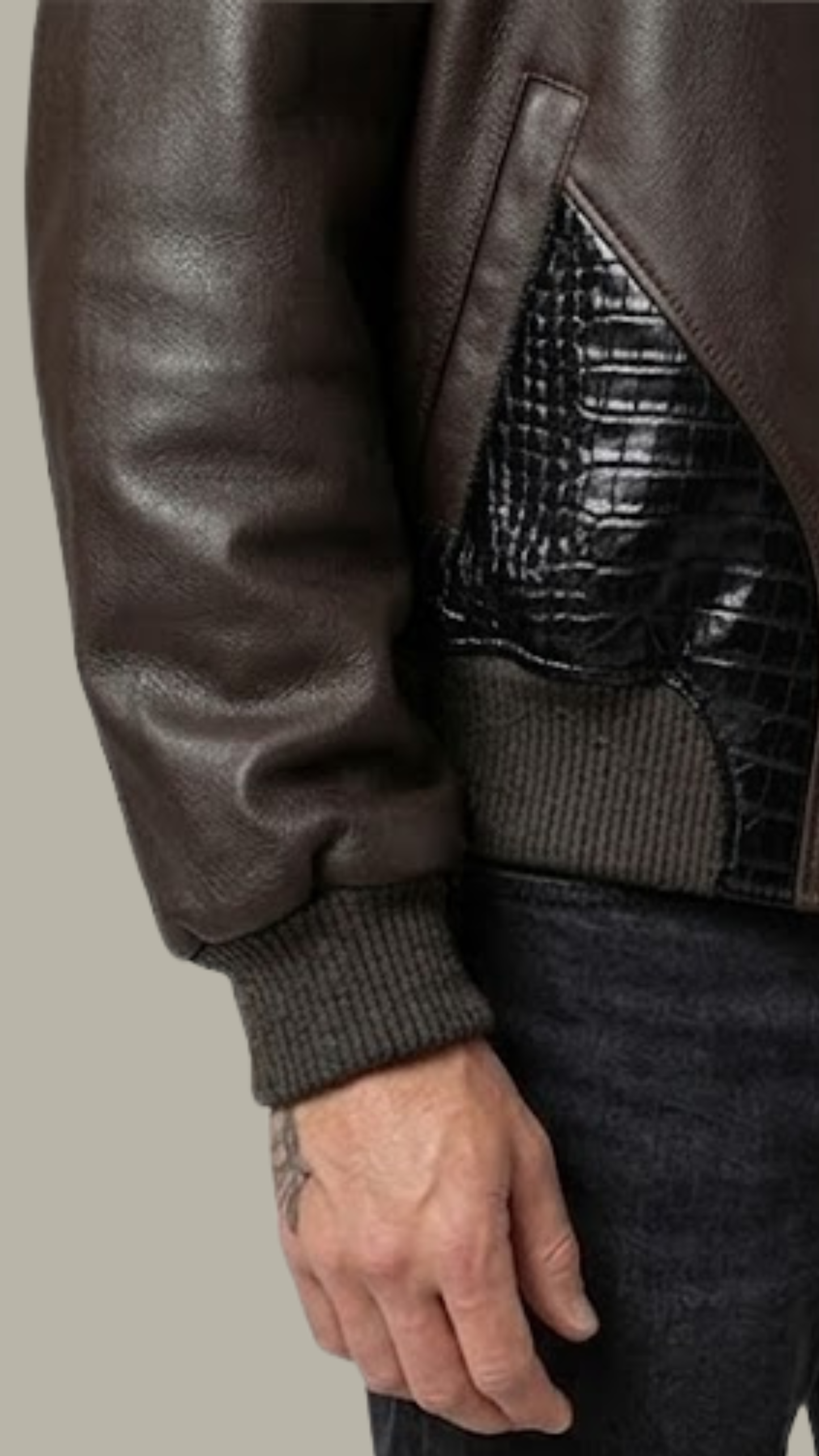Close-up shot showing the detailed embossing and high-quality finish of the black crocodile pattern on dark brown leather.