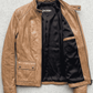 Jackero brand light brown genuine leather jacket presented on a clean studio backdrop, emphasizing premium lightweight craftsmanship.
