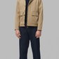 minimalist beige cotton jacket featuring a clean structured silhouette in a neutral sand tone.