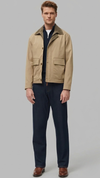 minimalist beige cotton jacket featuring a clean structured silhouette in a neutral sand tone.