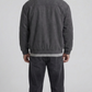 a minimalist dark grey suede jacket featuring simple cuffs and clean lines