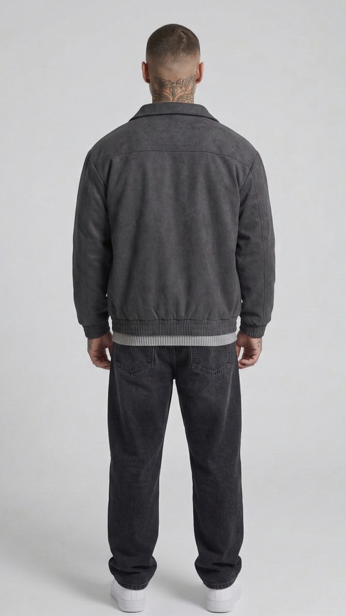 a minimalist dark grey suede jacket featuring simple cuffs and clean lines