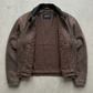 high-quality durable brown canvas fabric stitching and functional pockets on a utility jacket.