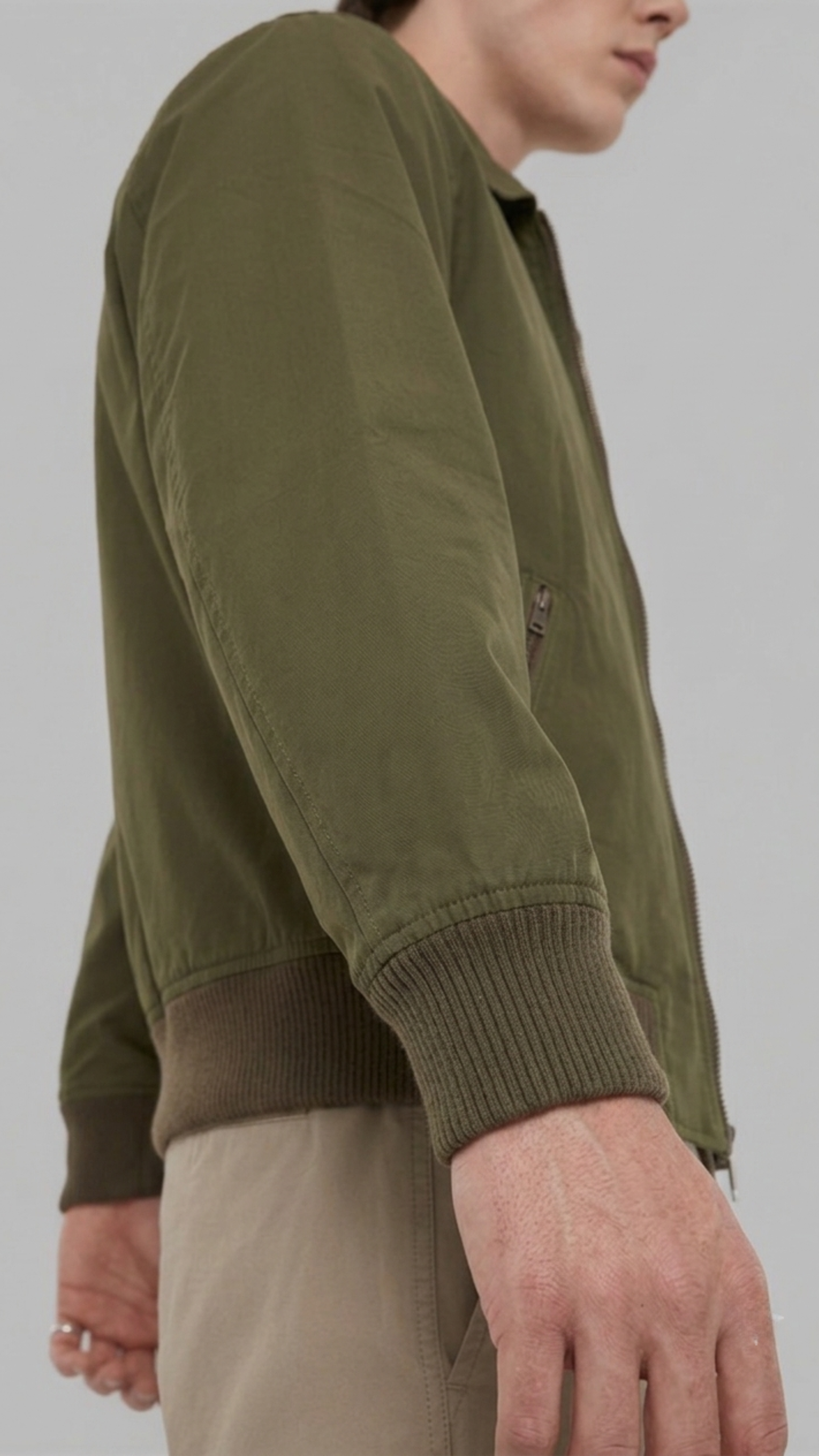 Close-up shot of the premium olive green cotton fabric weave and reinforced stitching on the jacket collar.