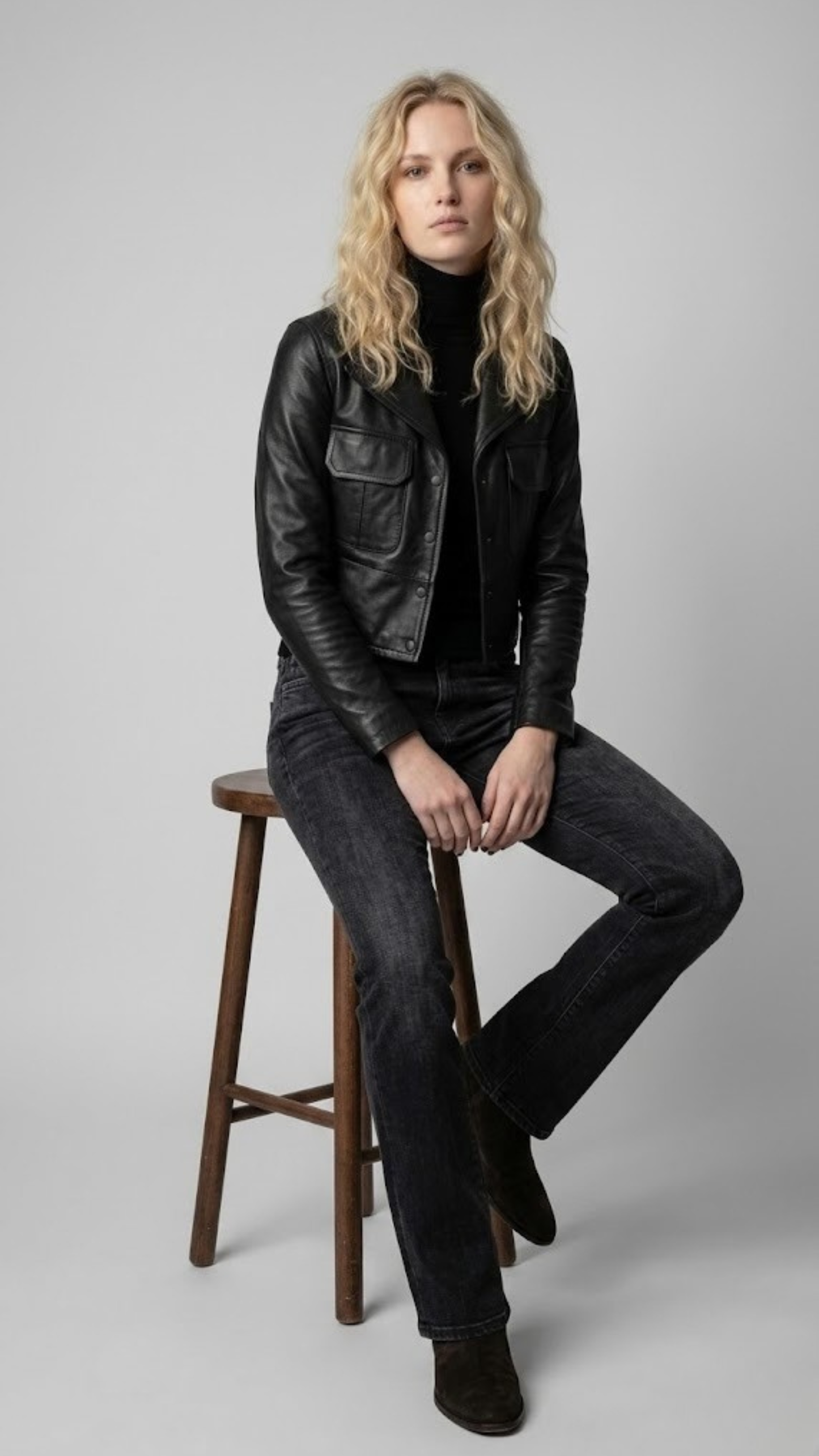 Symmetrical full-body studio photography of a versatile black leather jacket for catalog inventory.