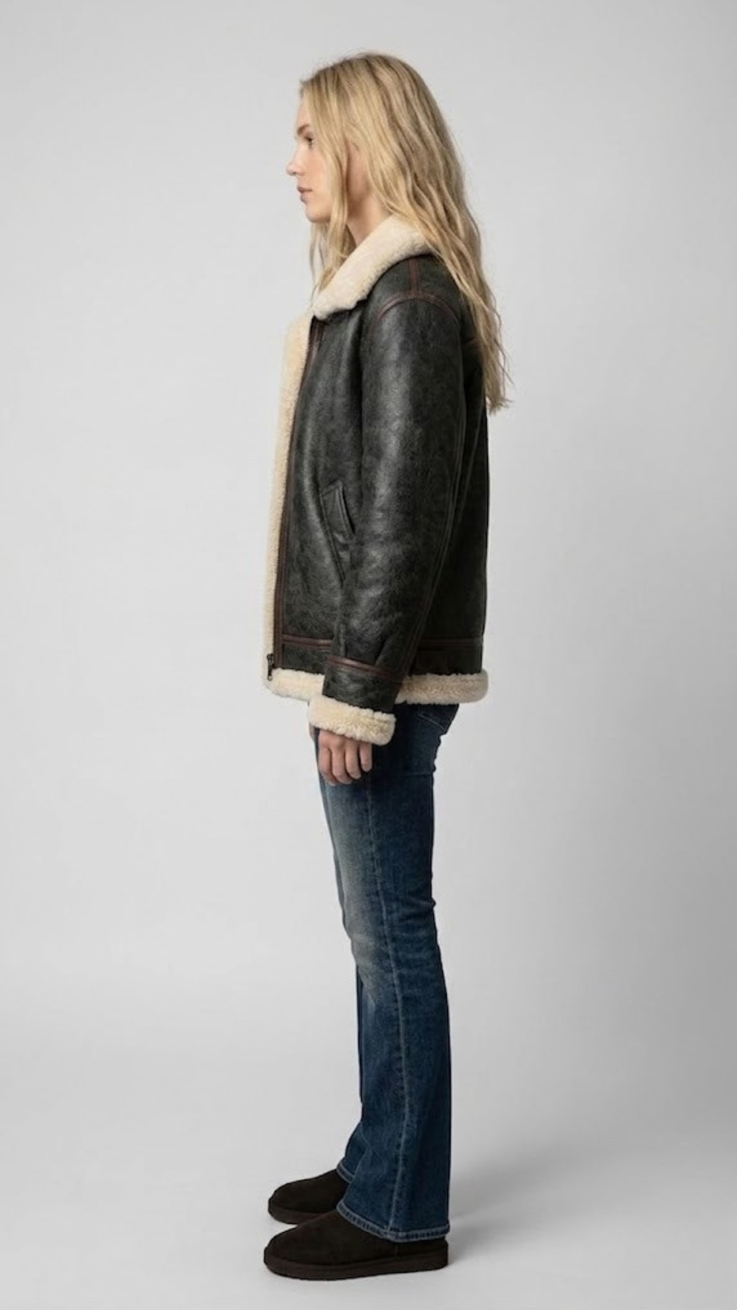 the rich texture of the soft faux cream fur lining against the premium black leather.