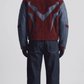 Back view displaying two-tone dark red suede and navy blue leather paneling on oversized silhouette jacket.