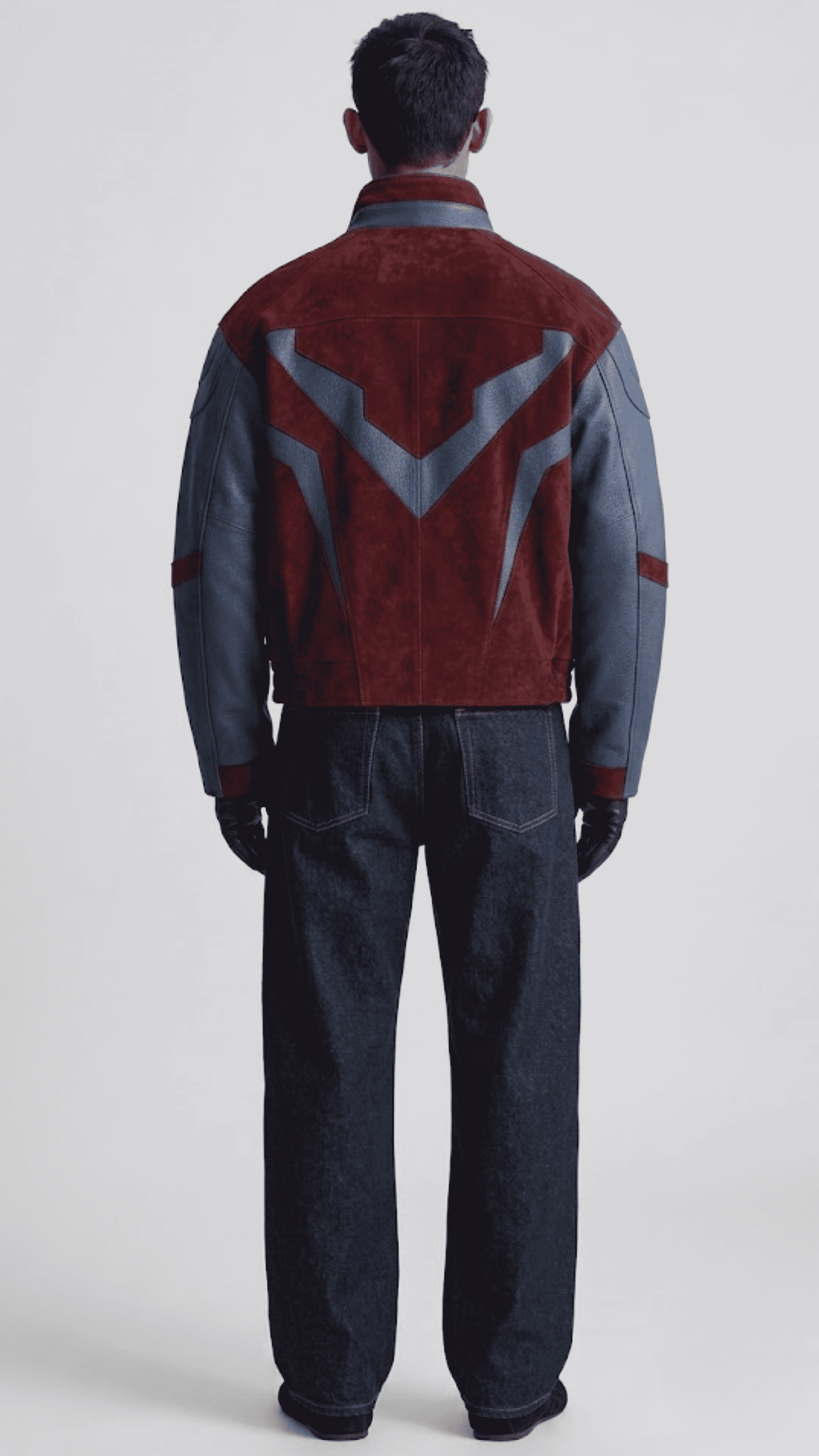Back view displaying two-tone dark red suede and navy blue leather paneling on oversized silhouette jacket.