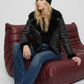 Model wearing a stylish black leather aviator jacket with a warm fur collar for a rugged winter streetwear look.