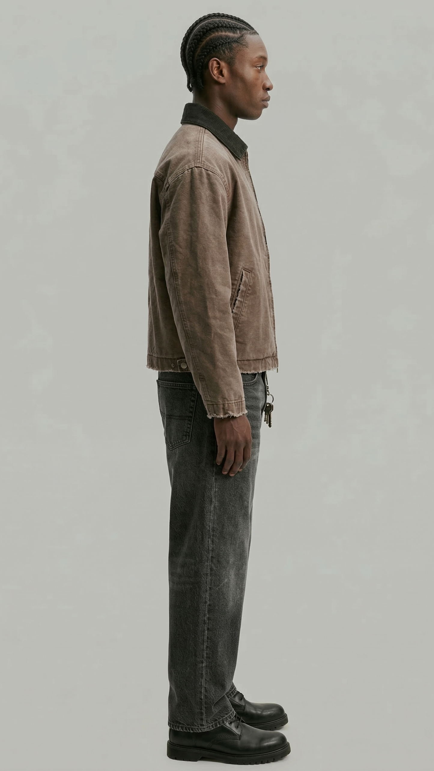 a casual brown cotton canvas jacket against a solid grey backdrop.