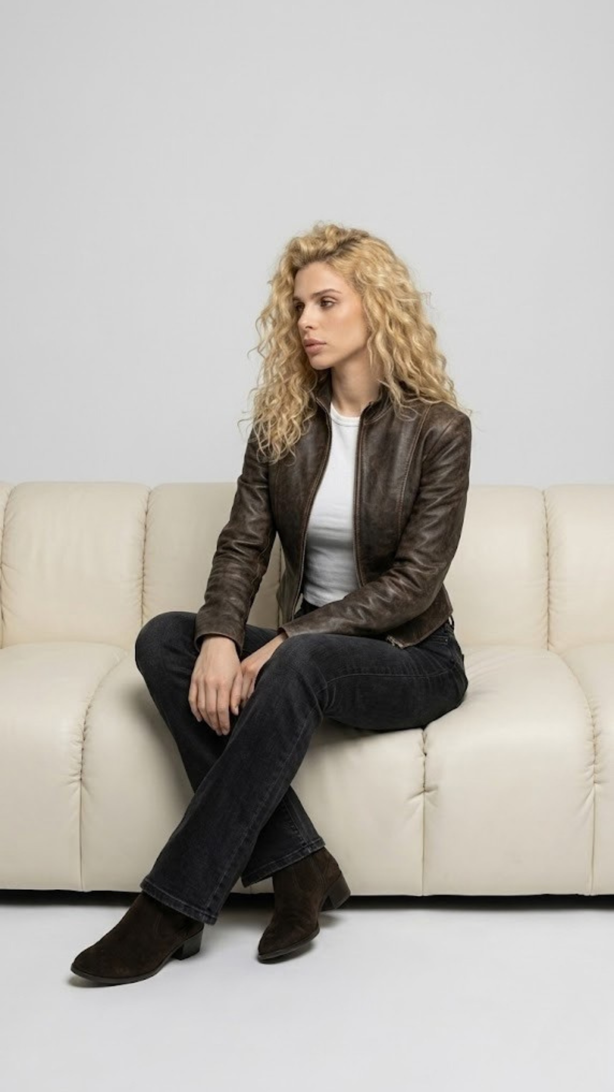 Rugged yet sophisticated masculine fashion concept featuring a dark brown distressed leather jacket styled for an effortless everyday look.