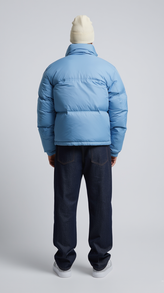Back view of a premium light blue winter puffer coat showing high-quality stitching and padded insulation details.