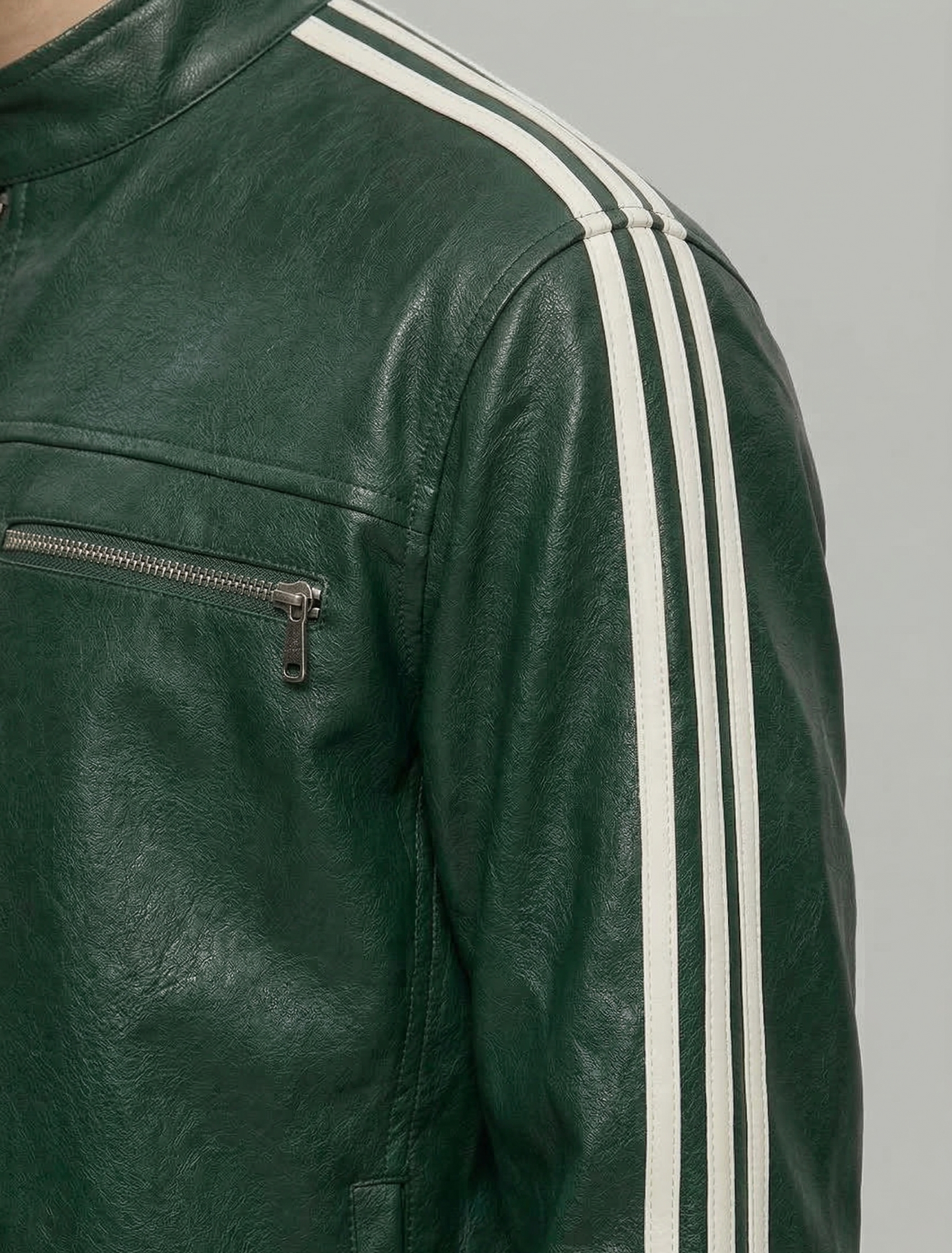 Green leather jacket with white stripes on a gray background