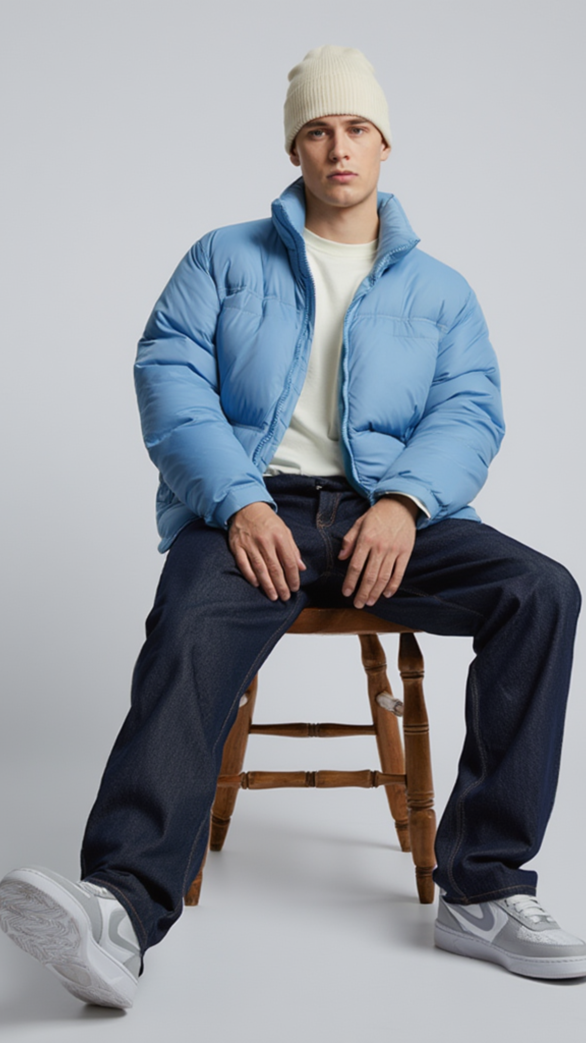 contemporary light blue streetwear puffer jacket paired with casual winter outfits.