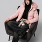a warm baby pink quilted jacket featuring a luxurious fur-lined hood for cold weather protection.
