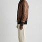 Side angle profile view highlighting the polished industrial hardware zipper and matching dark brown tailored hem lines of the flight outerwear.
