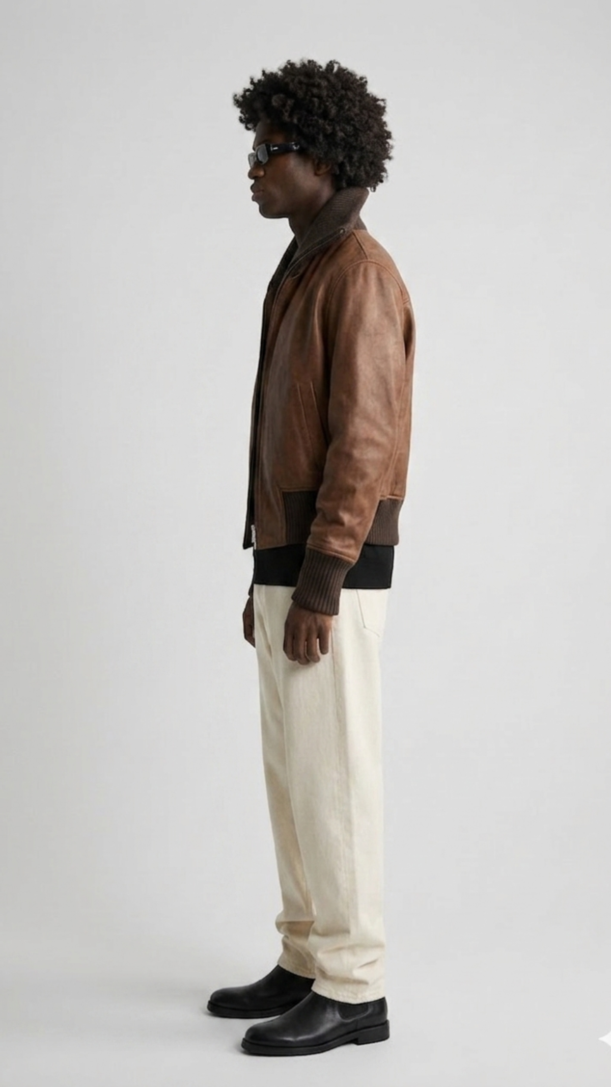 Side angle profile view highlighting the polished industrial hardware zipper and matching dark brown tailored hem lines of the flight outerwear.