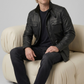 Men's rugged contemporary fashion showcasing a structured black leather military jacket styled for a bold, functional look.
