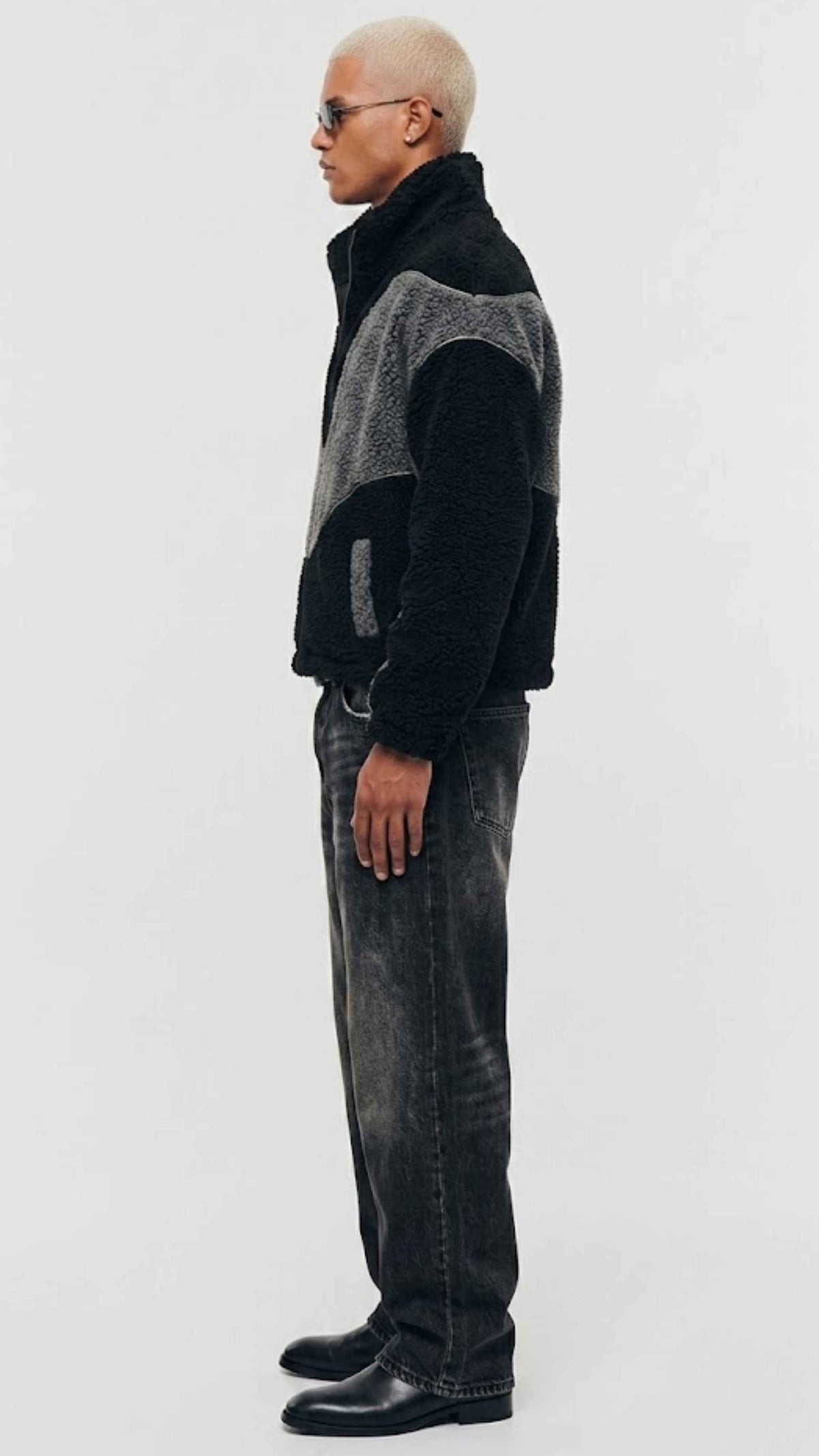 Side view highlighting slash waist pockets and heavy-duty structural stitching on wool blend fleece outerwear.