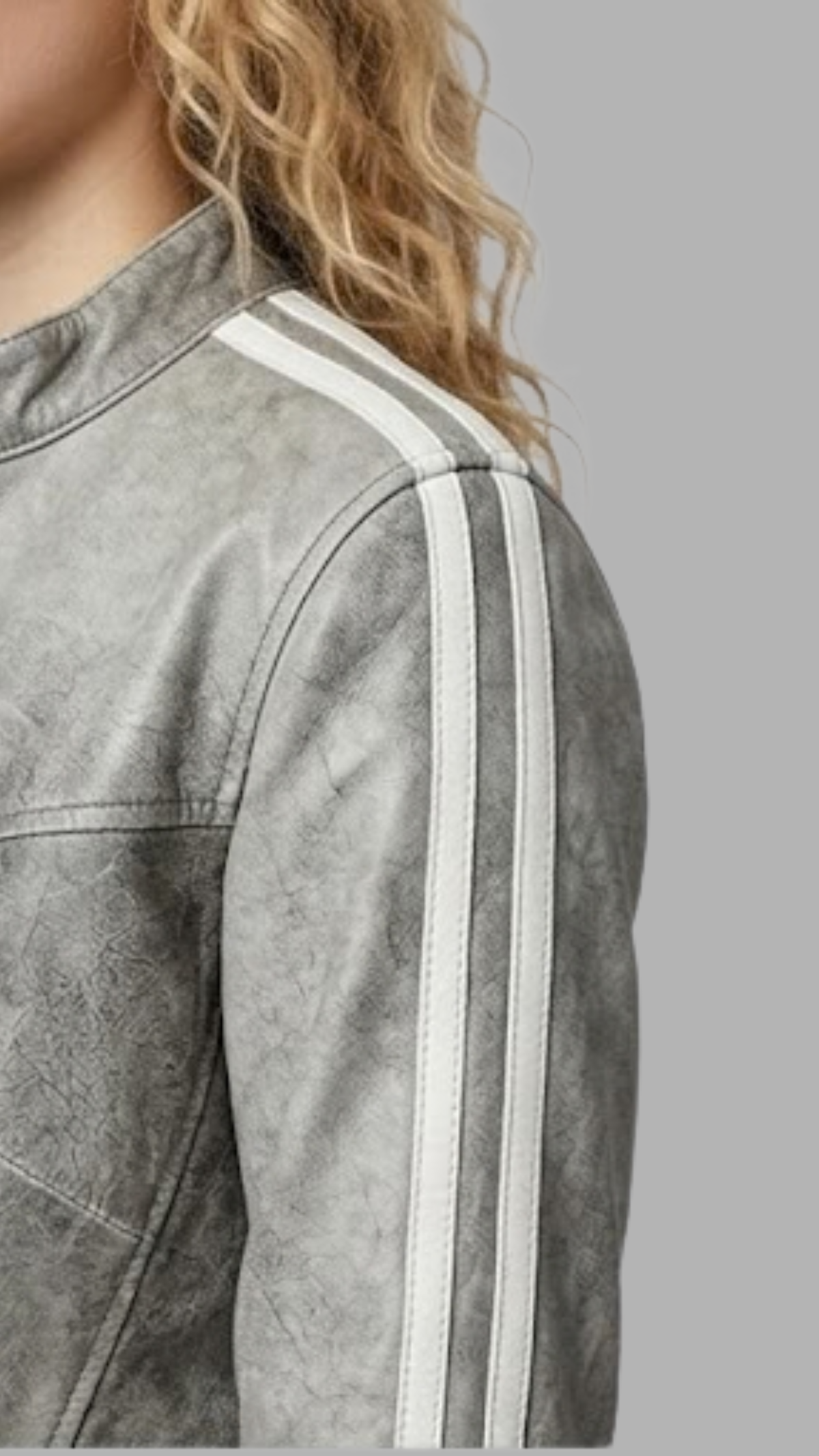 Close-up micro detail focusing on the rugged, worn-in texture and faded smoky seams of the grey distressed genuine leather material.
