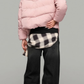 A jackero luxury women's short pink hooded puffer coat styled over a black crop top and dark relaxed-fit jeans.