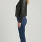 Full-length studio photography of a model wearing a stylish men's black leather motorcycle jacket paired with vintage jeans, showcasing a sleek streetwear look.