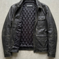 Jackero jacket flat lay photography of a high-end minimalist plain black leather coat displayed symmetrically on a solid grey backdrop.