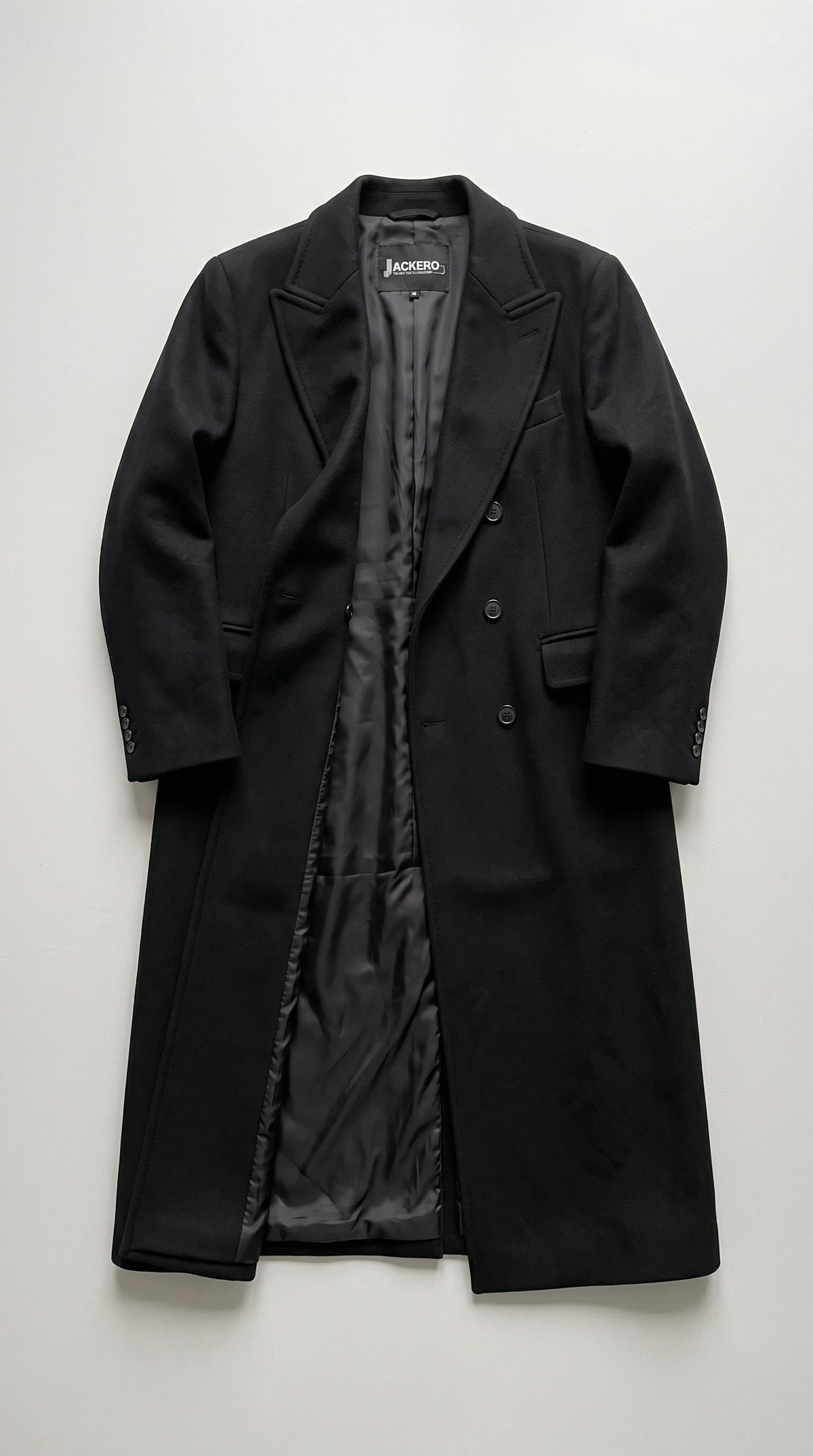 Experience unparalleled high-end fashion with the trendy Jackero pitch black double-breasted coat, the perfect warm statement piece for curating a sophisticated yet highly engaging streetwear look.