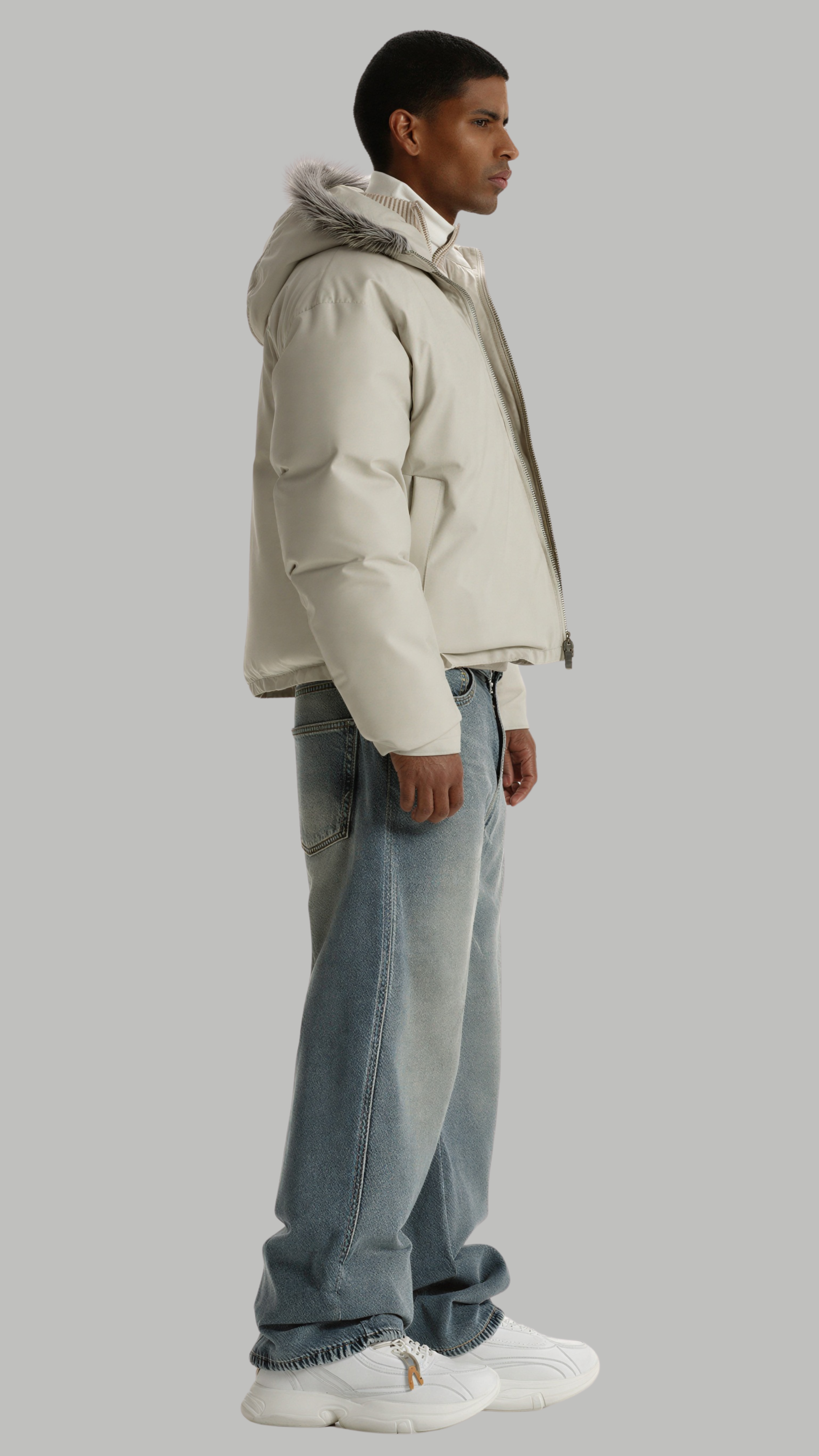 Studio photography of a model in a clean white puffer jacket, perfect for cold winter days.