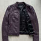E-commerce product flat lay presentation featuring the contemporary dark purple motorcycle jacket neatly arranged on a high-contrast background.