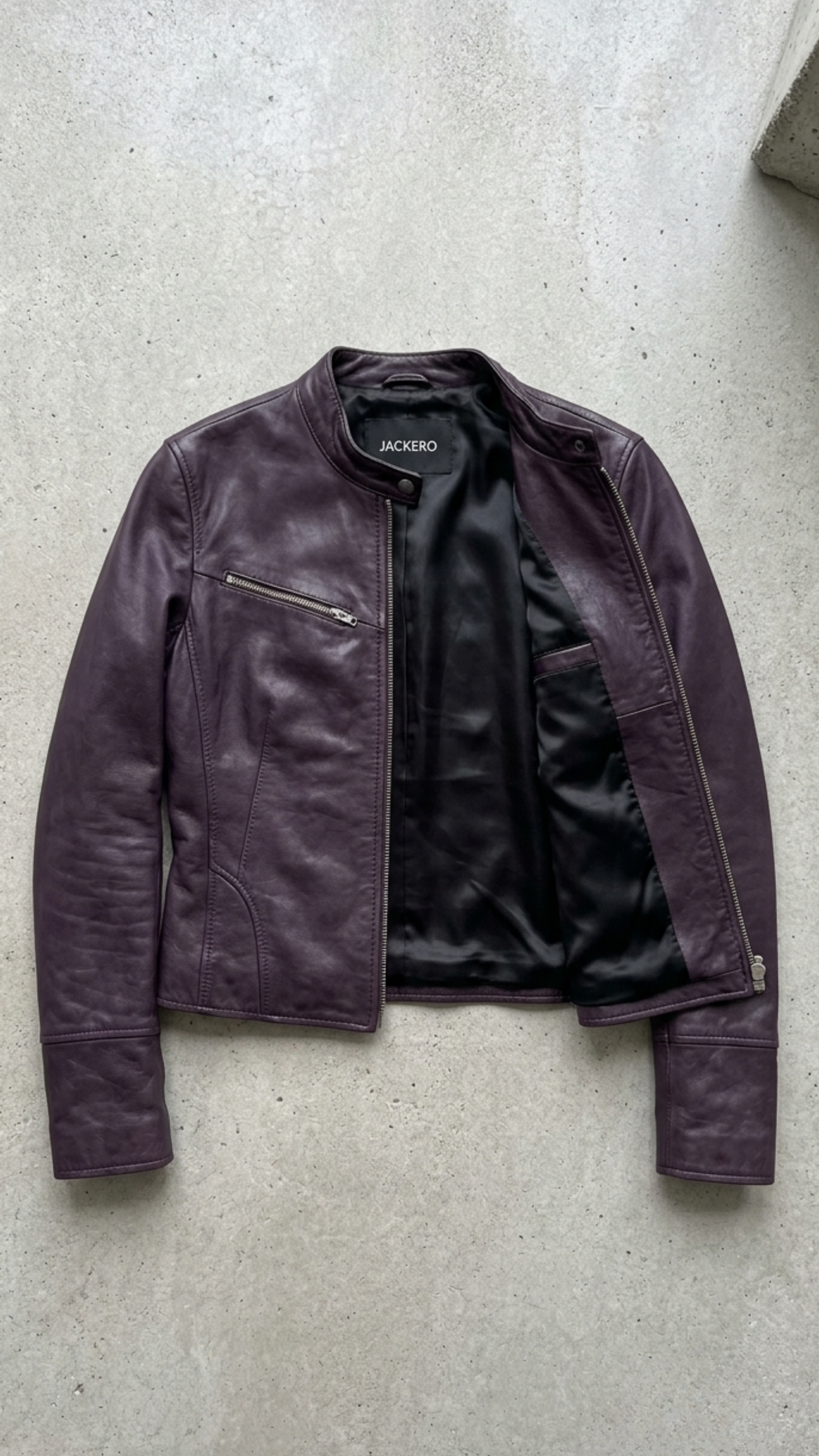 E-commerce product flat lay presentation featuring the contemporary dark purple motorcycle jacket neatly arranged on a high-contrast background.