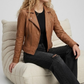 Premium women's style lookbook editorial showcasing a structured heritage outfit beautifully centered around a luxury tan leather motorcycle coat.