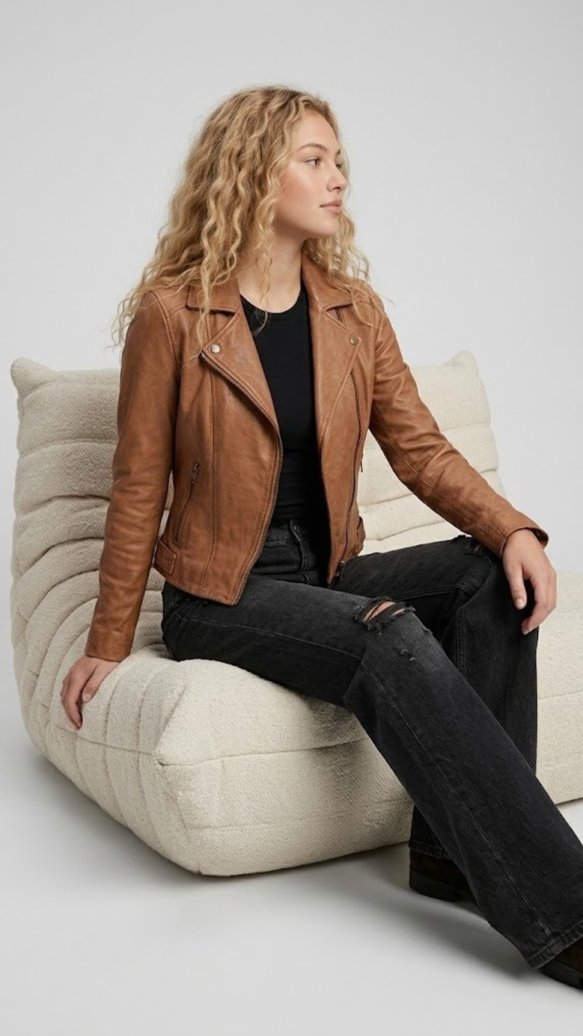 Premium women's style lookbook editorial showcasing a structured heritage outfit beautifully centered around a luxury tan leather motorcycle coat.