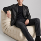 Men's contemporary high-fashion presentation featuring a sleek black leather sportcoat styled for an edgy, high-end look.