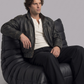 Men's edgy street fashion featuring a structured black distressed leather jacket styled for a timeless, rugged biker look.