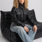 Contemporary urban street fashion featuring a structured black leather short jacket styled effortlessly for a bold, high-fashion layered look.