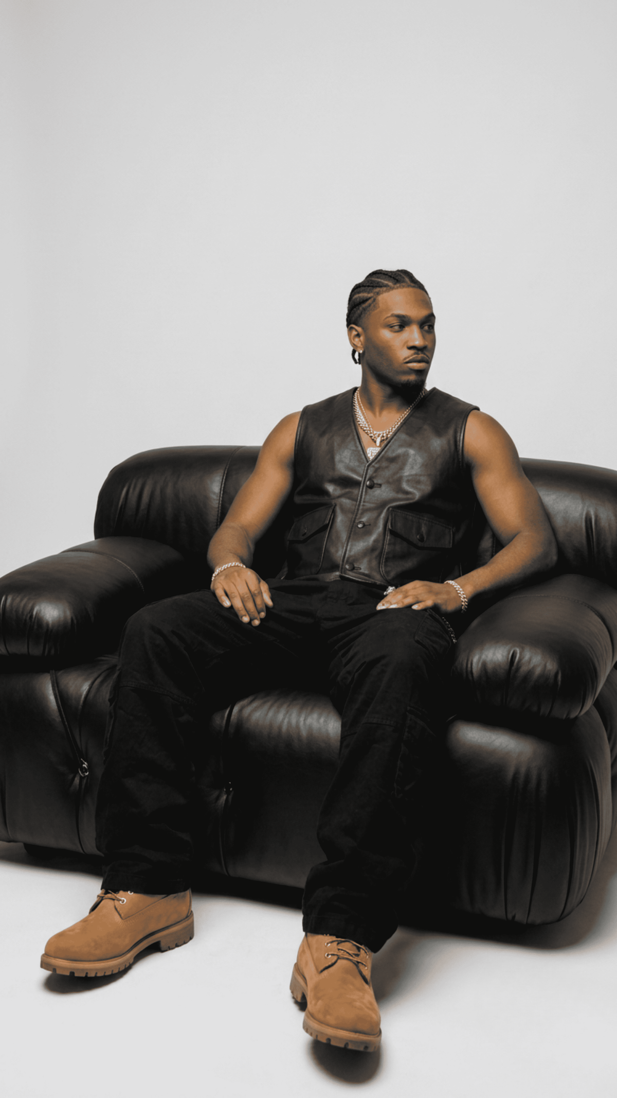 Men's sophisticated fashion featuring a stylish buttoned black leather waistcoat styled effortlessly for a sharp street-luxe look.