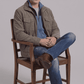 Men's urban streetwear fashion featuring a structured dark grey utility suede jacket styled for a rugged look.