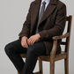 Men's sophisticated winter fashion showcasing a tailored dark chocolate brown wool overcoat for a sharp, formal look.